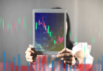 Investor and trader concept - investor with tablet and tradeview graph and marketting reports on tablet screens in his modern.