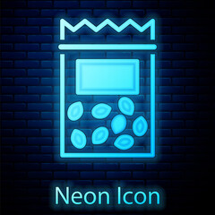 Glowing neon Pack full of seeds of a specific plant icon isolated on brick wall background. Vector