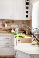 The vegetables are on the table next to the sink. Kitchen faucet, sink, kitchen, vegetables. Healthy food, healthy lifestyle