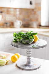 Fresh organic vegetables and lemons are on the table in the kitchen. Ingredients for making a green detox smoothie