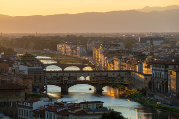 Fototapeta na wymiar The Ponte Vecchio, the old bridge with its reflection in the Arno river in Firenze, Florence, Italy