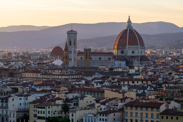 Fototapeta na wymiar Florence or Firenze sunset aerial cityscape. Panorama view from Michelangelo park square. Ponte Vecchio bridge, Palazzo Vecchio and Duomo Cathedral. Tuscany, Italy