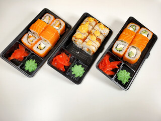 Assorted sushi rolls on an isolated white background. Delivery of Japanese cuisine.