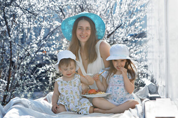 a happy family walks through a flower meadow. Love and spring blooming. Mother with daughter...