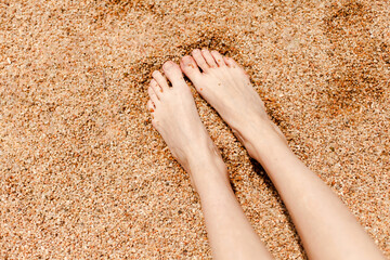 woman legs on the sand in spain