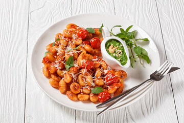 Potato gnocchi with tomatoes and pesto, top view