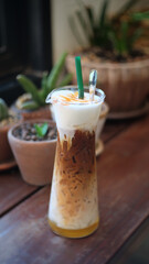 Ice Coffee in the wooden table cafe