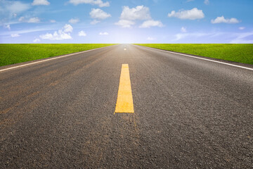 Naklejka premium Highway in perspective view and nature landscape. Consist of long straight line on asphalt road or way and empty horizon sky background at outdoor or countryside. Concept for trip, journey and freedom