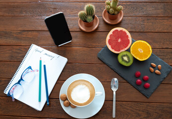 Healthy breakfast with fruits and cappuccino on wooden table
