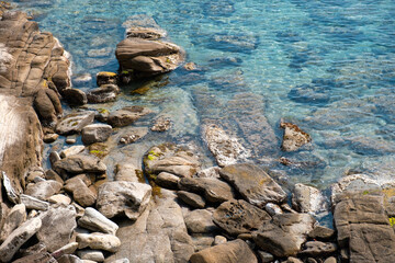 Rocky beach with calm beautiful sea at sunny day. Greece