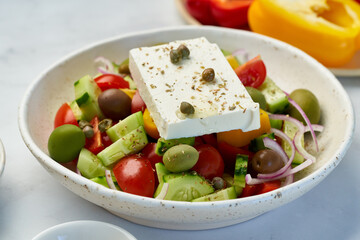 Greek village salad horiatiki with feta cheese and vegetables, vegeterian mediterranean food, low calories keto dieting meal, side view, close up