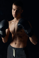 sports guy on a black background in boxing gloves inflated torso cropped view Model 