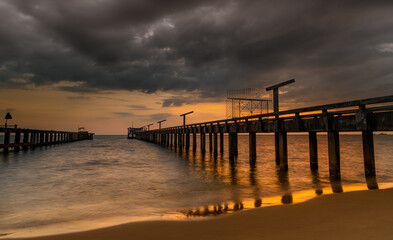 Fototapeta na wymiar Long sea bridge in the sunset time.