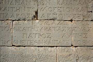 Ancient greek writing on stone wall of ancient city of Patara, Turkey