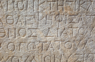 Ancient greek writing on stone in ancient city of Patara, Turkey. Close up detail