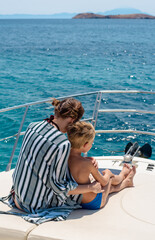 Brother and sister enjoy yachting cruise. Summer vacation for family at luxury yacht.