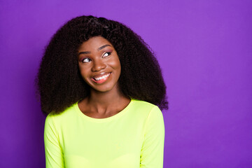Photo of dreamy minded lady look up empty space white smile wear yellow shirt isolated violet...