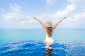 Portrait beautiful young asian woman relax smile leisure around outdoor swimming pool