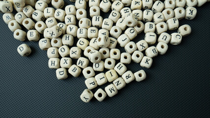 The alphabet wood cube on black background  for  education concept