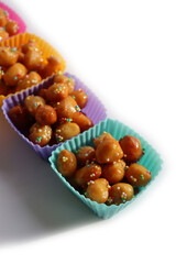 Traditional italian fried Struffoli with honey and sugar sprinkles  isolated on white background