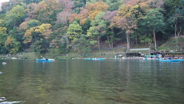 A timelapse of people playing around yakata bune boats.   Arashiyama Kyoto Japan
