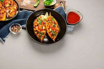 Stuffed sweet potato with spiced chickpea, dressing and herbs.