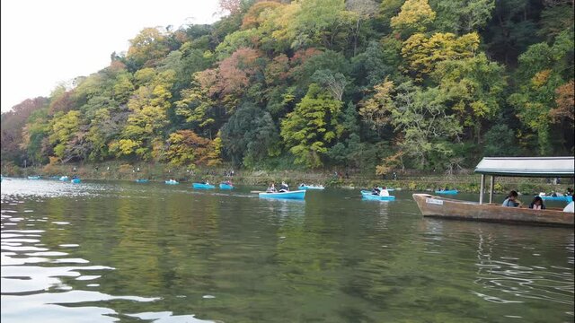 A timelapse of people playing around yakata bune boats.   Arashiyama Kyoto Japan
