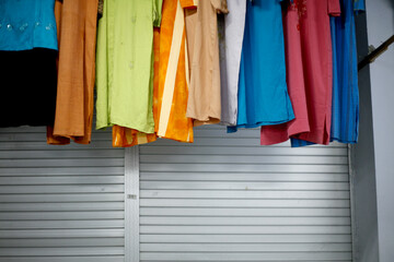 colorful clothes hanging on front store