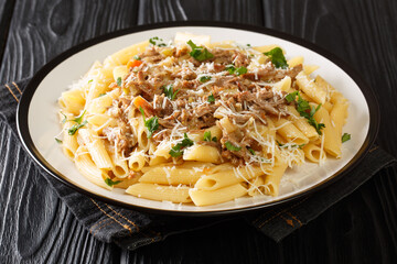 Penne pasta alla Genovese sauce with beef, wine and vegetables close-up on a plate on the table. horizontal