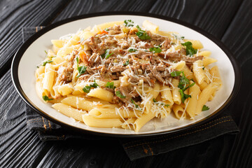 La genovese the meat and onion sauce of&nbsp;Naples and penne pasta close-up on a plate on the table. Horizontal