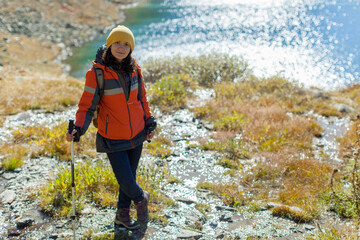 Trekking woman portrait. Autumn mountain road landscape. Adventure solo tourism isolation concept. New modern nomad. Healthy active lifestyle, vitality, zen. Photo with copy space