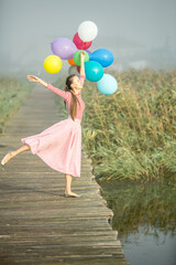 Young woman with balloons  early in the morning © PEPPERSMINT