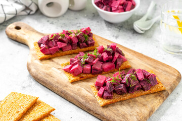 Bruschetta with pickled beet, apple and mayonnaise. Sandwich or crostini on a serving wooden board...