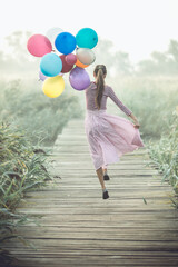 Young woman with balloons  early in the morning © PEPPERSMINT