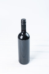 Black bottle of wine and glasses isolated on white