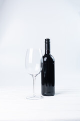 Black bottle of wine and glasses isolated on white