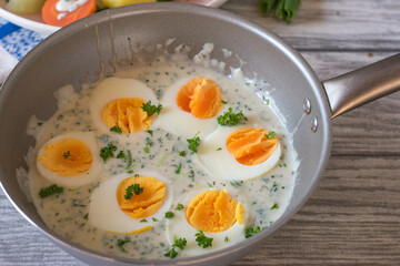 A pot with boiled eggs and sauce