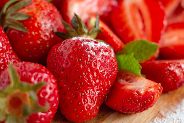 Appetizing juicy bright strawberries, sprinkled with powdered sugar - vitamin composition, the taste of summer