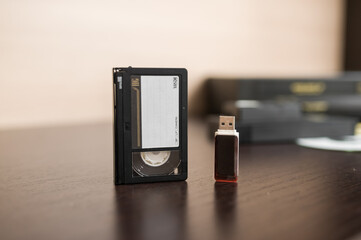 videotape and cd on brown wooden background