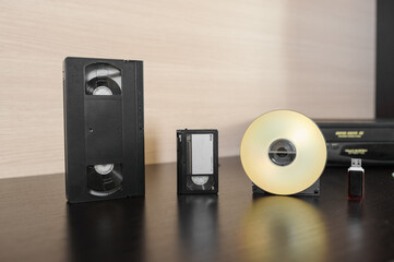 videotape and cd on brown wooden background