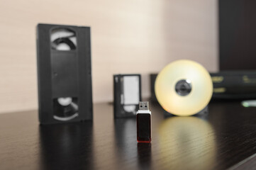 videotape and cd on brown wooden background