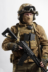 Male soldier in tactical equipment and uniform (coyote brown color) . Shot in studio on a white...