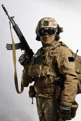 Male soldier in tactical equipment and uniform (coyote brown color) . Shot in studio on a white...