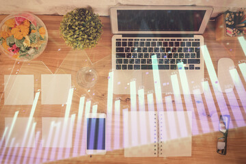 Stock market graph and top view computer on the table background. Multi exposure. Concept of financial education.