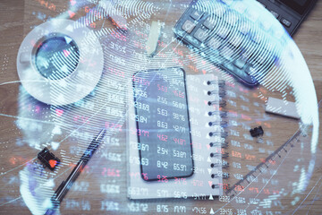 Double exposure of business theme hologram over desktop with phone. Top view. Mobile international trade connection concept.
