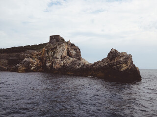 Liguria, Italy - June 15, 2020: Travelling around the ligurian seaside. Panoramic view to the seaside and the old villages. An amazing caption of the medieval coloured houses with grey sky.