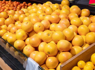 Fresh oranges in the store. Crates full of ripe mandarin and clementines, oranges for sale at the counter. Selective focus