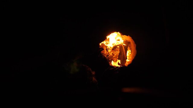 Hands warming up in a fire done in metal barell.