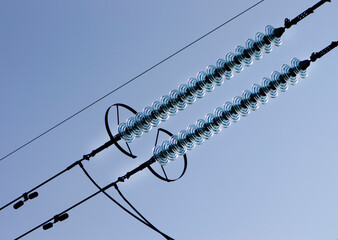 power line of cables and insulators close up. electrical insulators support cables placed on...