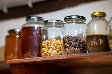 Coffee peels in a glass jar on a shelf in a coffee shop. Beautiful interior design